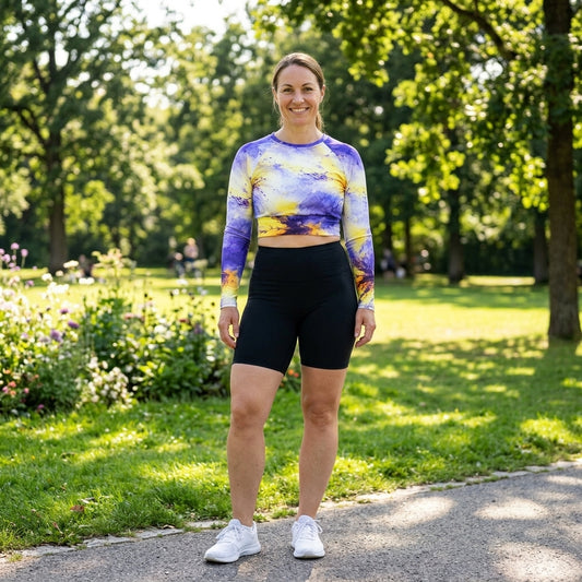 Model standing in a park wearing a Penny Purple Picotee long-sleeve crop top.