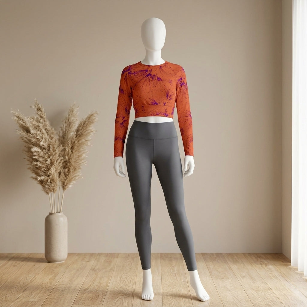 Mannequin wearing Admire Orange Purple Wing crop top and leggings set