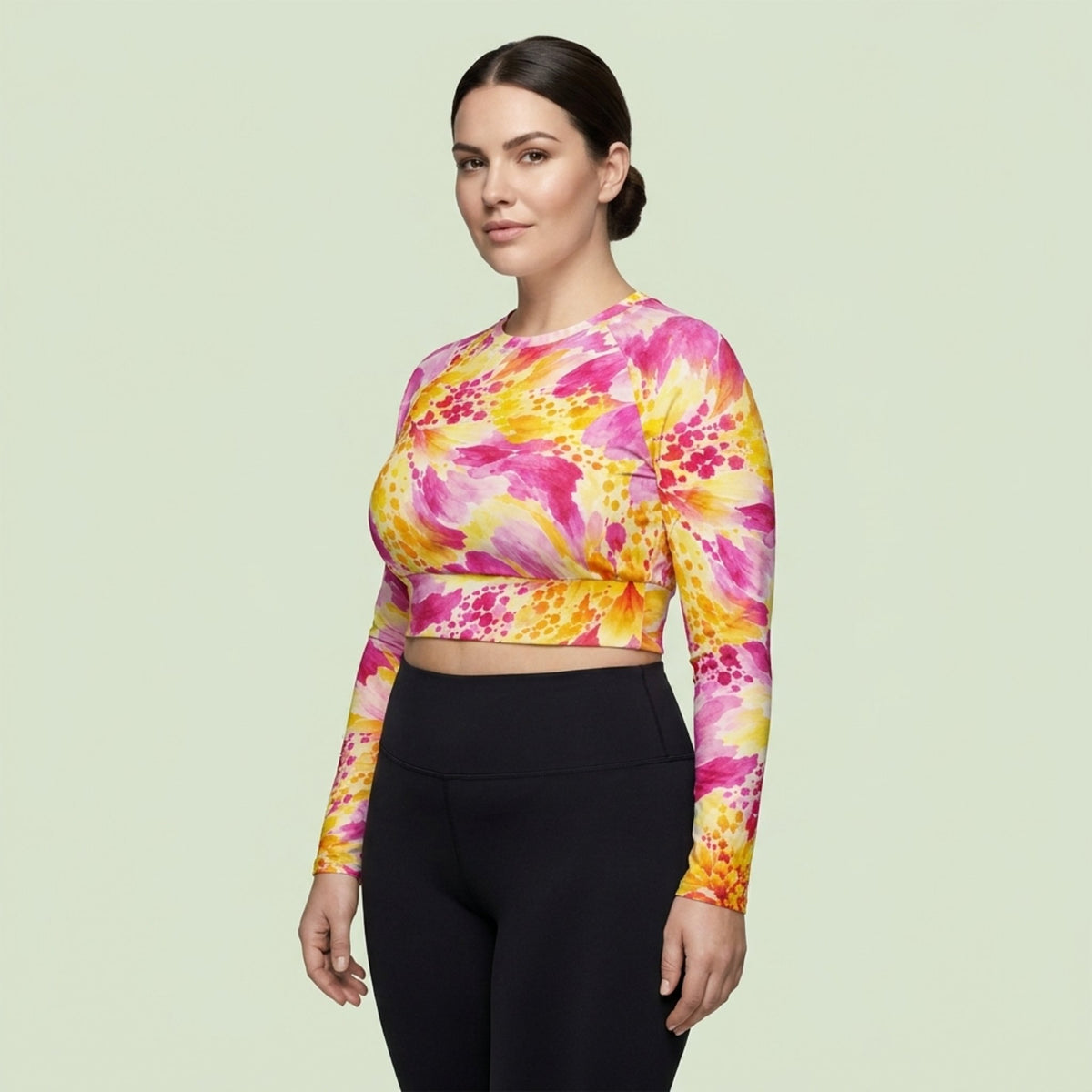 Model wearing Labyrinth Dahlia print long-sleeve crop top, posing in activewear