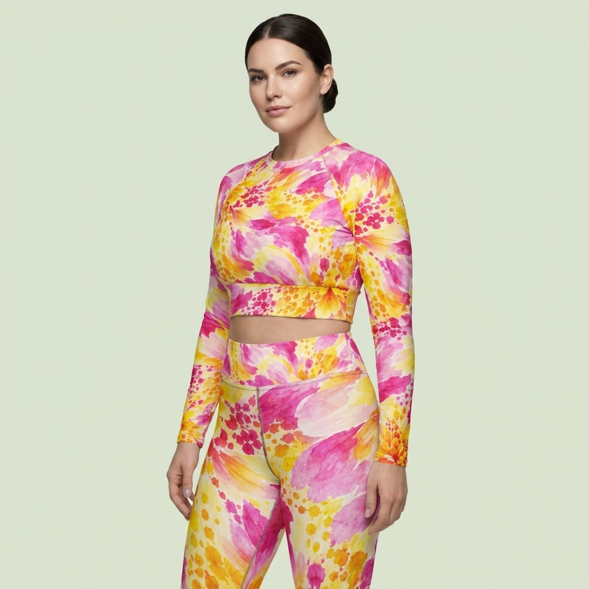 Model wearing Labyrinth Dahlia print long-sleeve crop top, posing in a studio