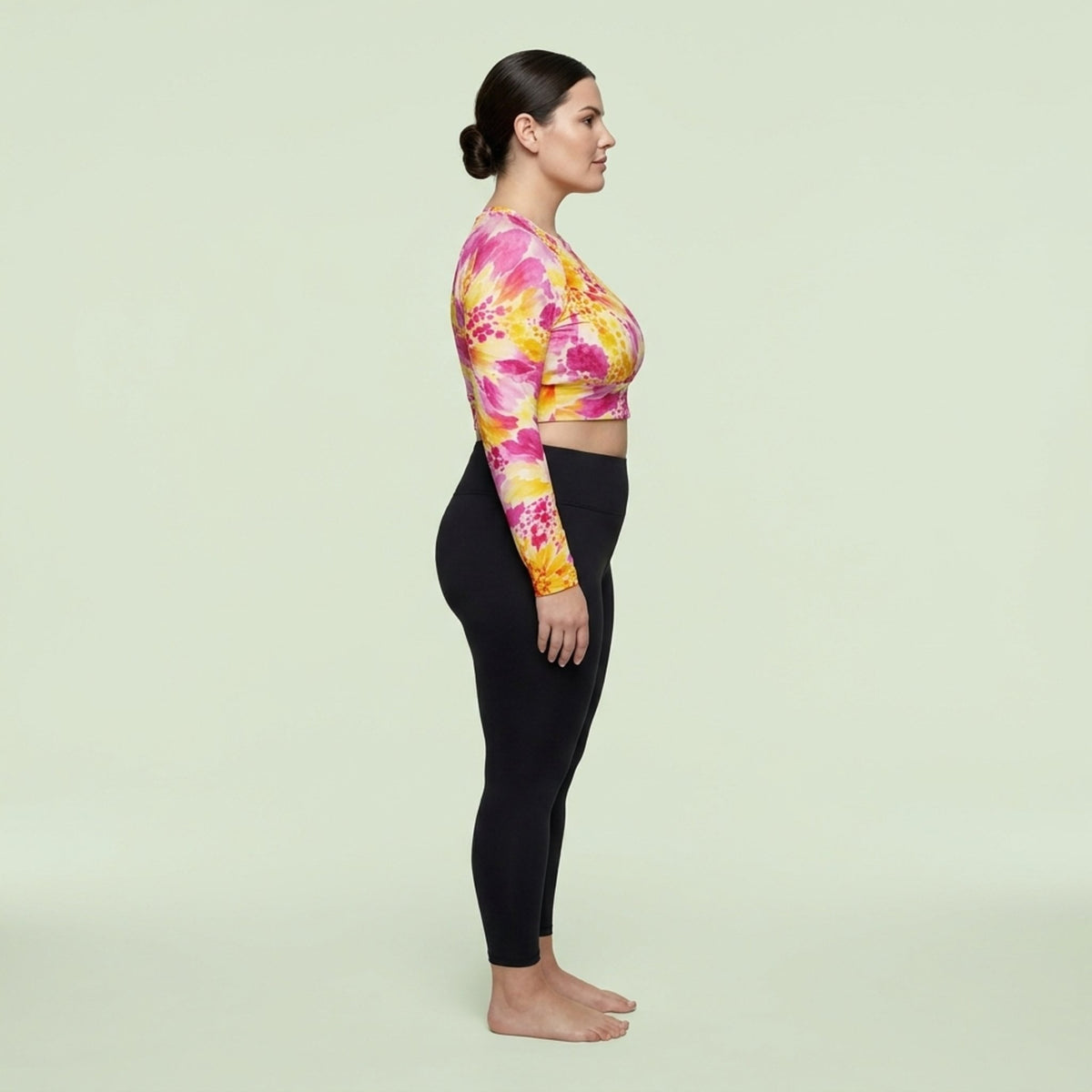 Model wearing Labyrinth Dahlia print long-sleeve crop top, posing in a studio