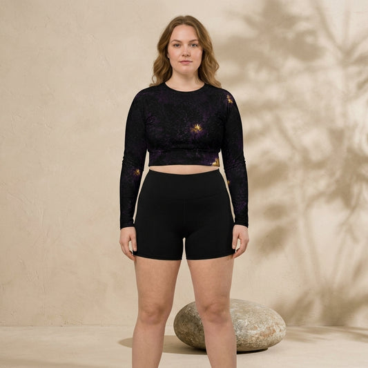 Model wearing black activewear crop top in studio