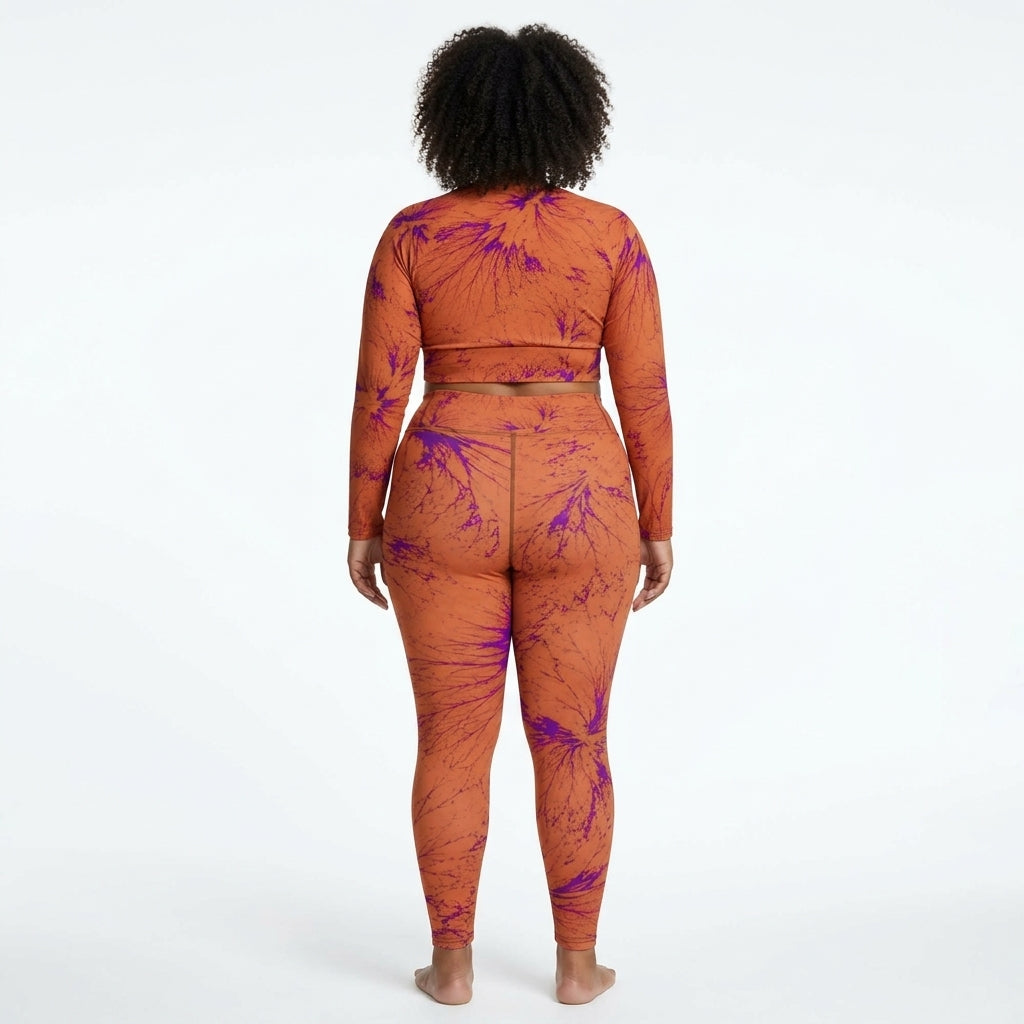 Model wearing a matching Admire Orange Purple Wing athletic set.