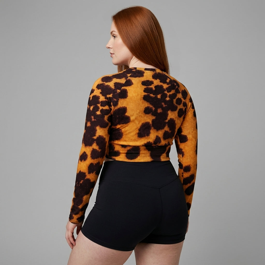 Model wearing Tiger Orchid (gold and burgundy) long-sleeve crop top.