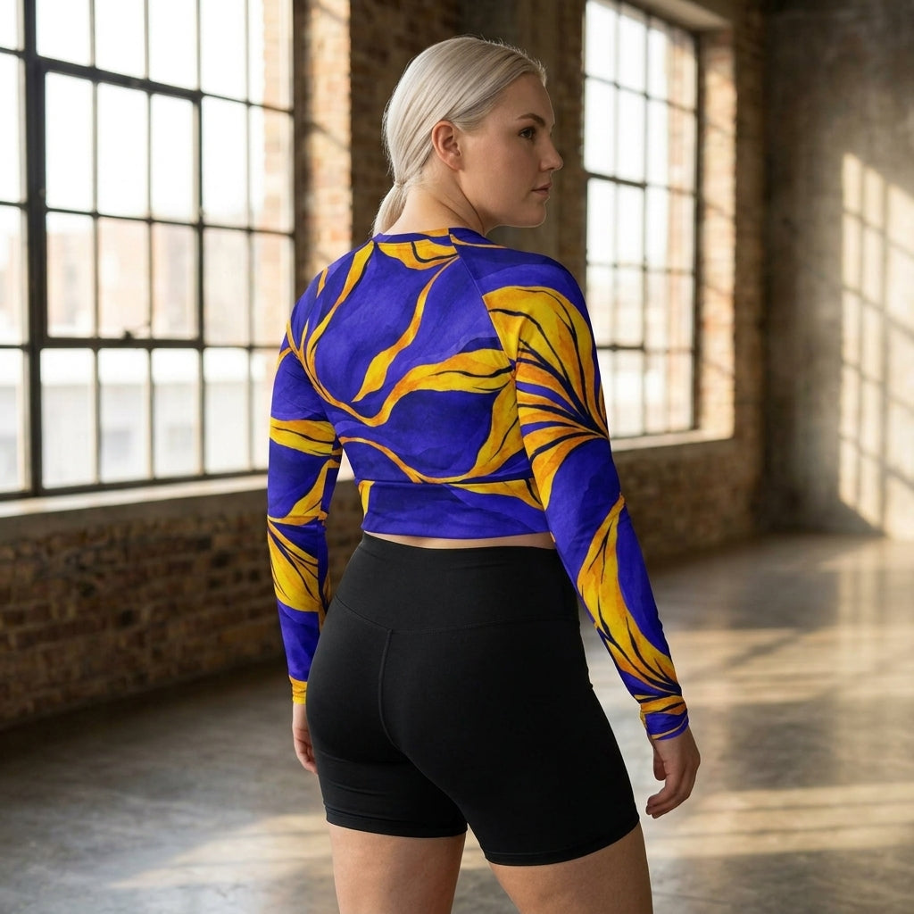 Woman posing in blue and yellow activewear shorts and crop top