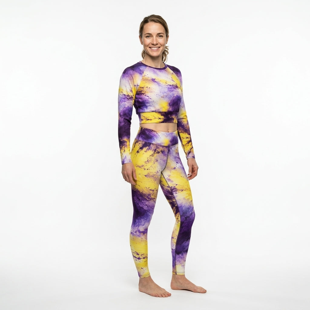 Model wearing a matching Sorbet Midnight Glow activewear set, standing in a white studio.