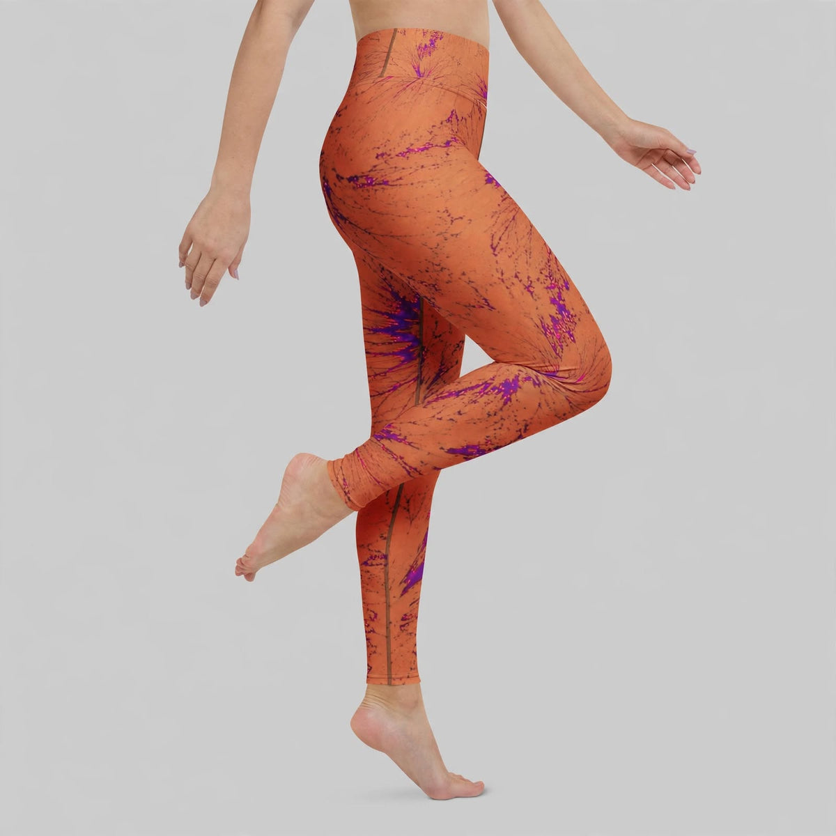 Model posing in Admire Orange Purple Wing viola print leggings