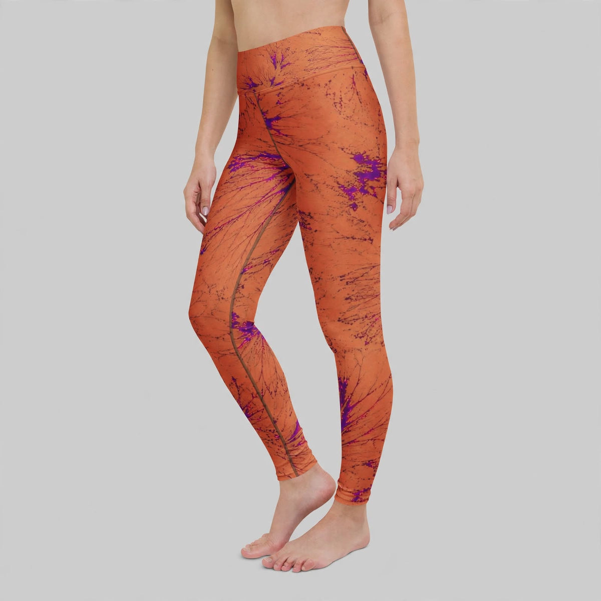 Model wearing Admire Orange Purple Wing viola print leggings