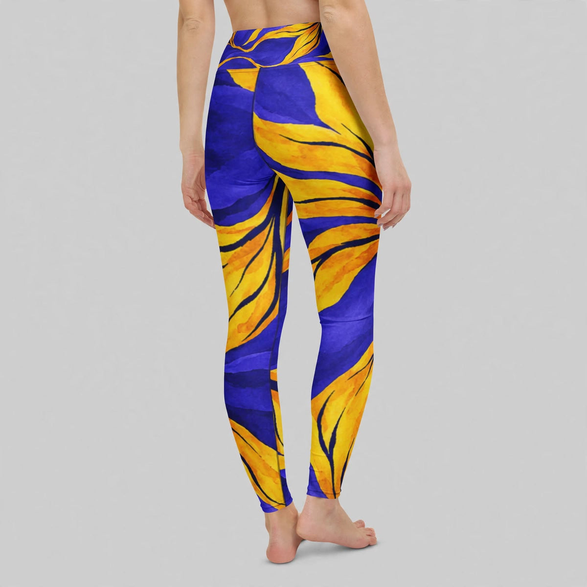 Person wearing purple floral-print leggings in studio
